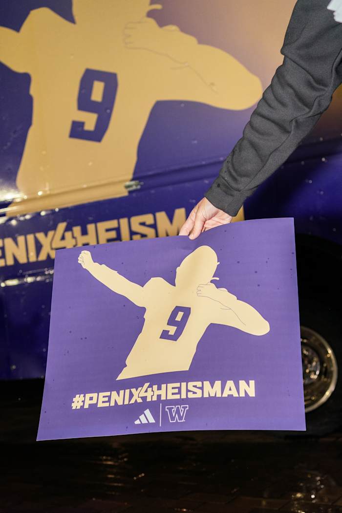 A purple and gold adidas sign reading, "#Penix4Heisman."